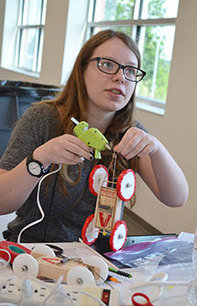Illinois Science Olympiad contestant examines her project.